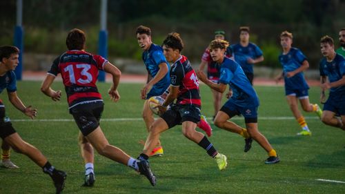 Free Exciting rugby match with young athletes in action on a lush green field. Stock Photo
