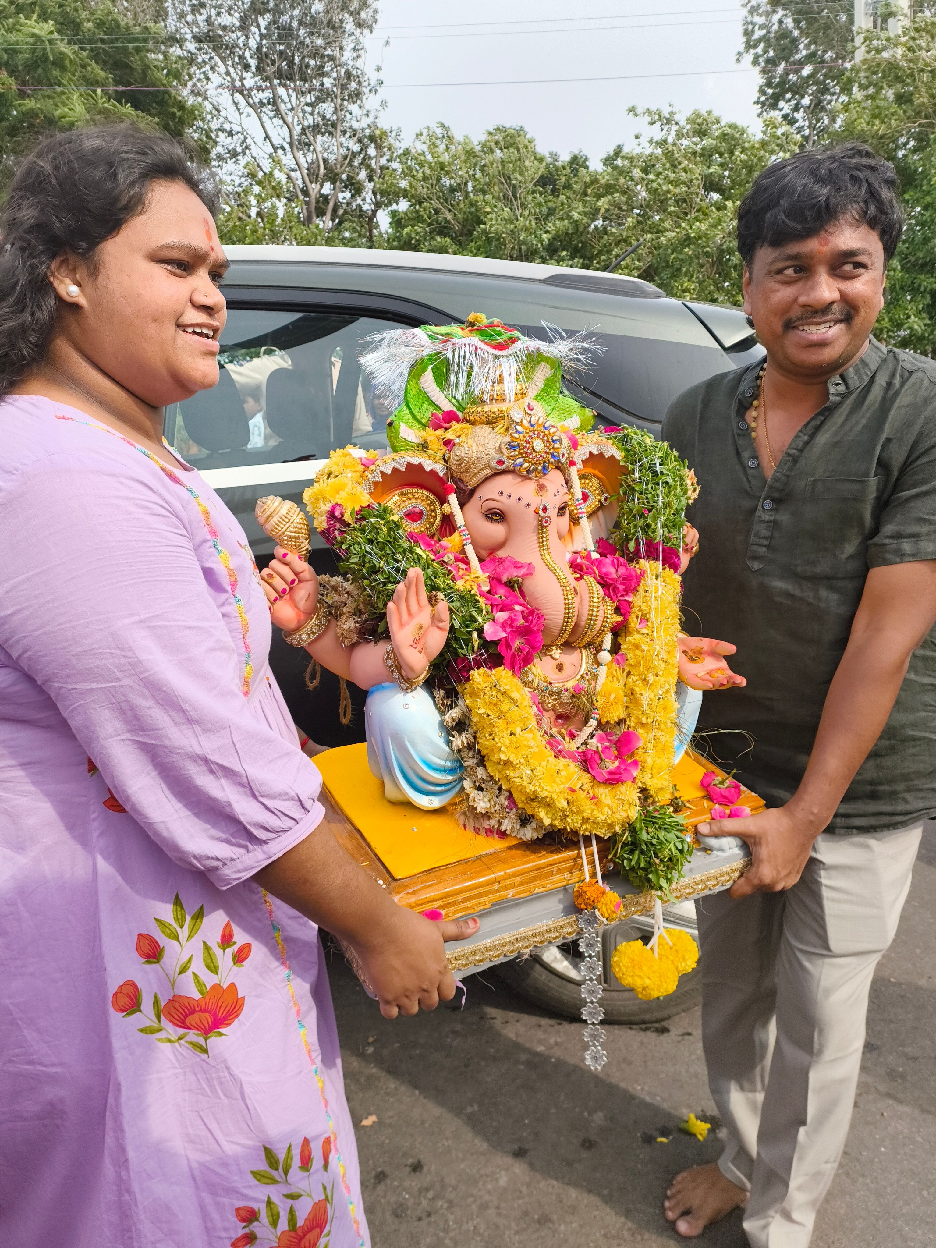 People carrying a decorated Ganesh statue during Ganesh Chaturthi.