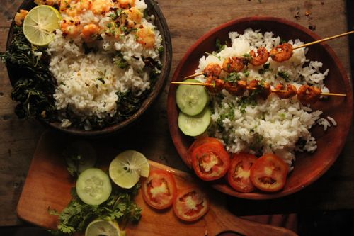 Free Top view of shrimp and rice bowls with sliced cucumber and tomatoes, garnished with cilantro. Stock Photo