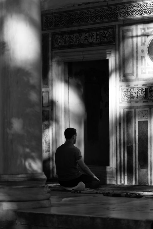 Free An individual meditates in a historic architectural setting with intricate designs. Stock Photo
