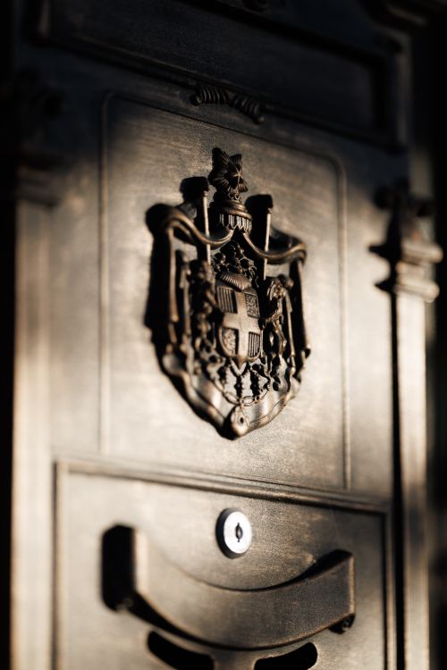 Free Close-up of a wooden door featuring a detailed medieval coat of arms in Sovetsk, Russia. Stock Photo