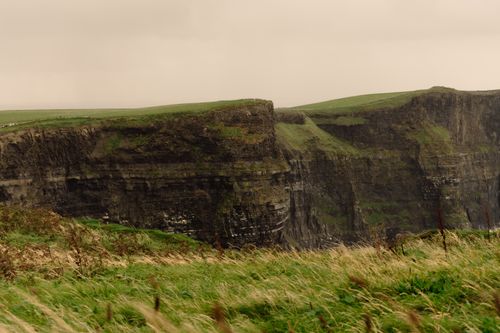 Free Scenic view of the Cliffs of Moher in Ireland, showcasing rugged cliffs and lush green landscape. Stock Photo