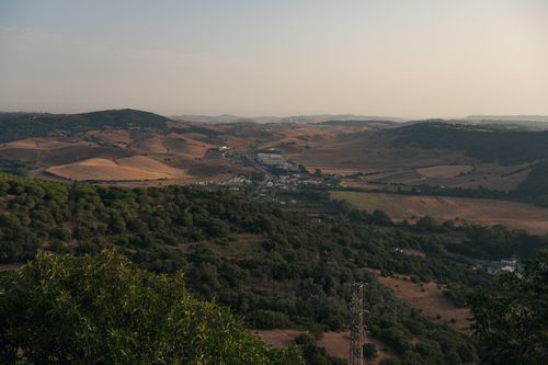 Free A breathtaking landscape of rolling hills and farmland in Andalusia, Spain at dusk. Stock Photo