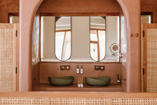 Modern bathroom design in a boutique hotel in Jambiani, Tanzania featuring elegant fixtures and natural materials.