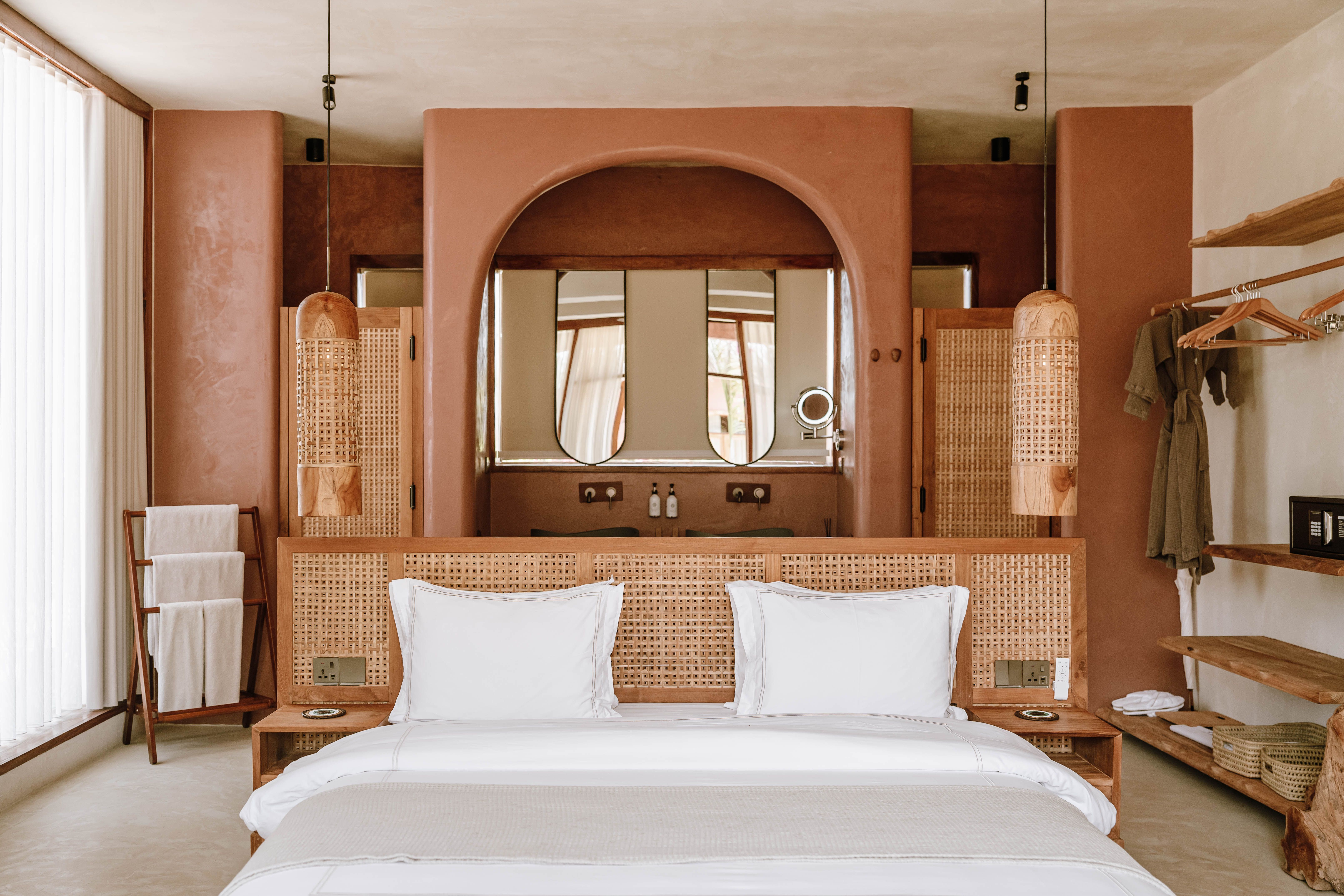 Elegant hotel room interior with neutral tones and rustic decor in Jambiani, Tanzania.