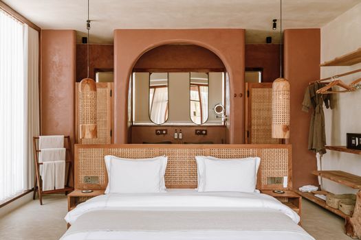 Elegant hotel room interior with neutral tones and rustic decor in Jambiani, Tanzania.