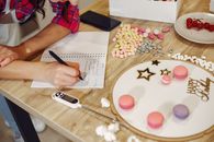 Woman taking notes among pastry decorations