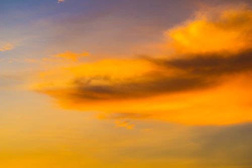 Free A stunning sunset with rich orange and purple hues, capturing dramatic cloud formations. Stock Photo