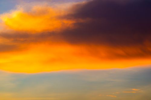 Free A scenic view of vivid orange and blue clouds during sunset, capturing nature's beauty. Stock Photo
