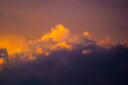 Free Spectacular sunset clouds with vibrant orange and purple hues creating a dramatic sky scene. Stock Photo