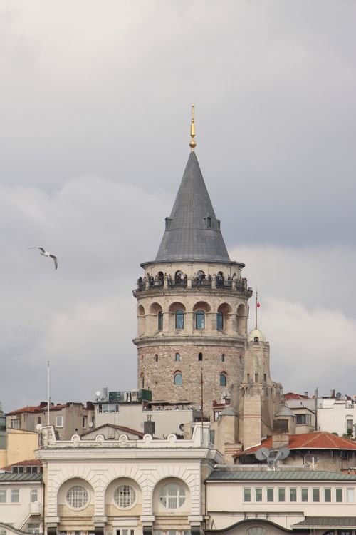 Free View of the iconic Galata Tower towering above the Istanbul skyline with cloudy skies. Stock Photo