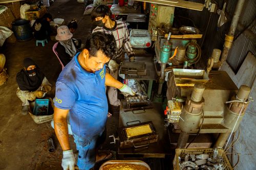 Free Workers focus on operating industrial machinery in a factory workshop. Stock Photo