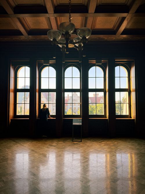 Free Beautiful interior with large arched windows overlooking the city, capturing elegance and tranquility. Stock Photo