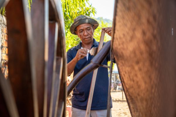 A boatbuilder working on a wooden hull
