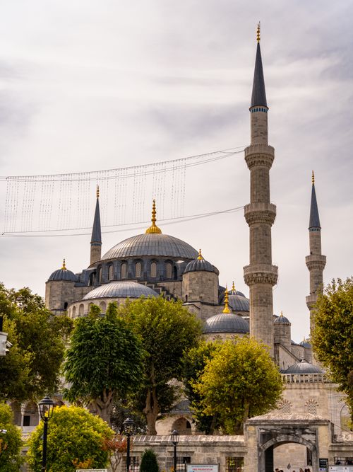 Free A scenic view of Istanbul's historic Blue Mosque with its iconic domes and minarets under a cloudy sky. Stock Photo