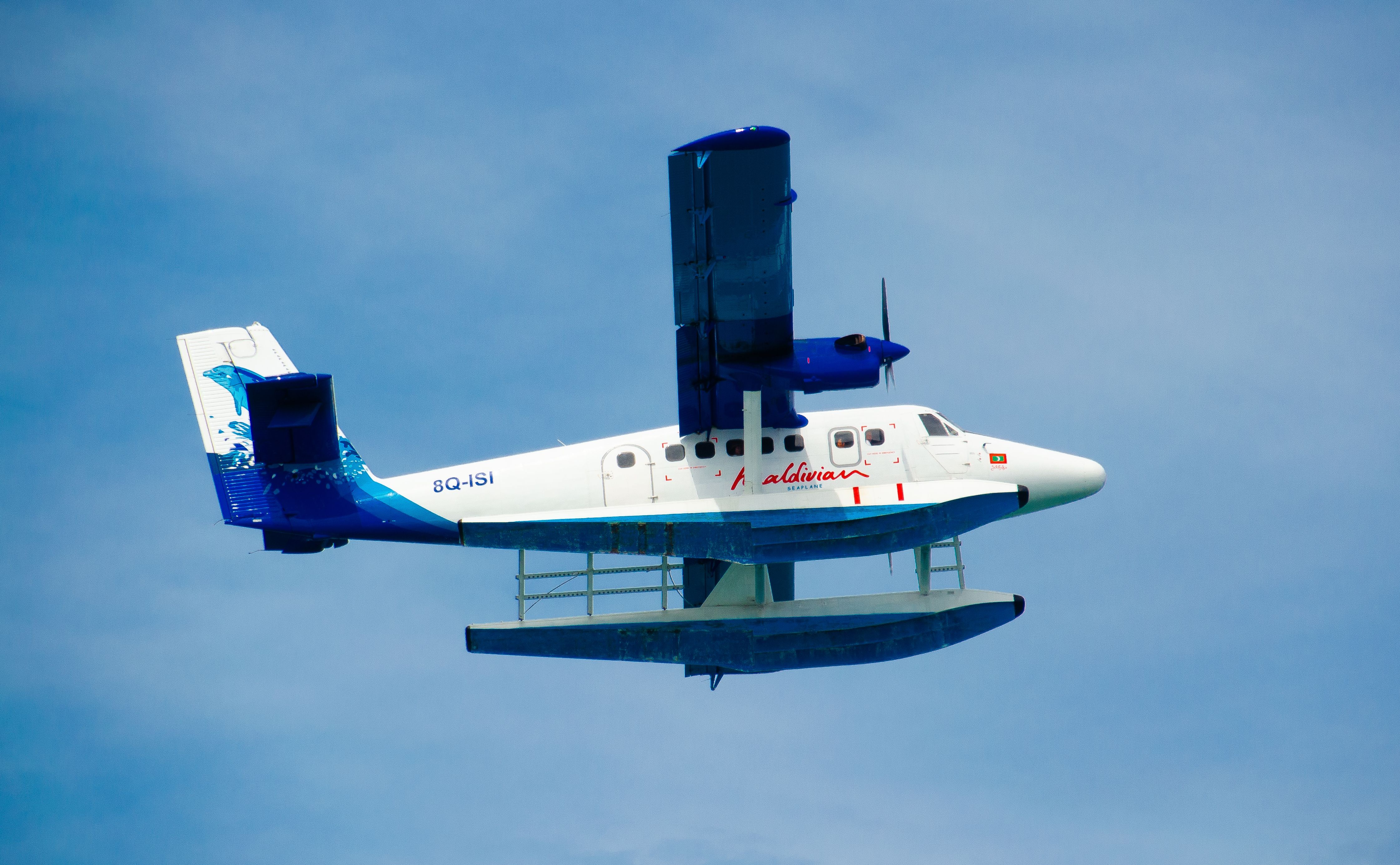 A Maldivian seaplane soaring through bright skies, evoking a sense of travel and adventure.