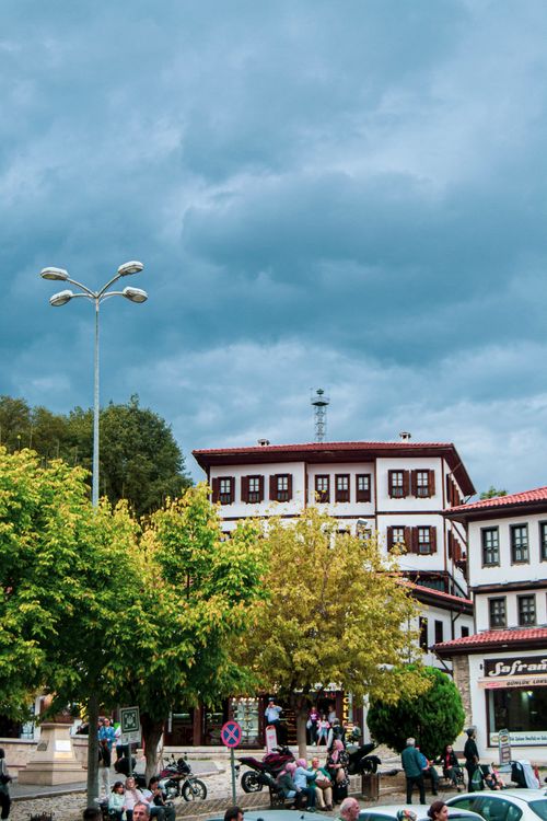 Free A vibrant city square featuring historic buildings under a dramatic sky. Stock Photo