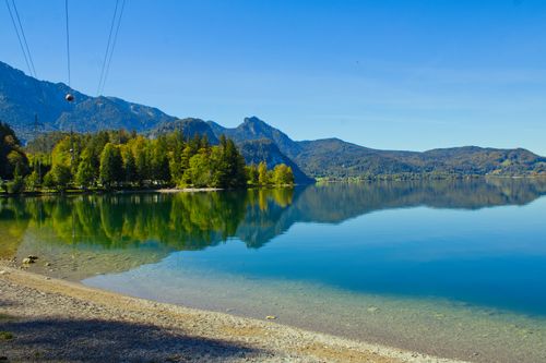 Free Peaceful Bavarian lake landscape with clear blue sky and mountain reflection. Stock Photo
