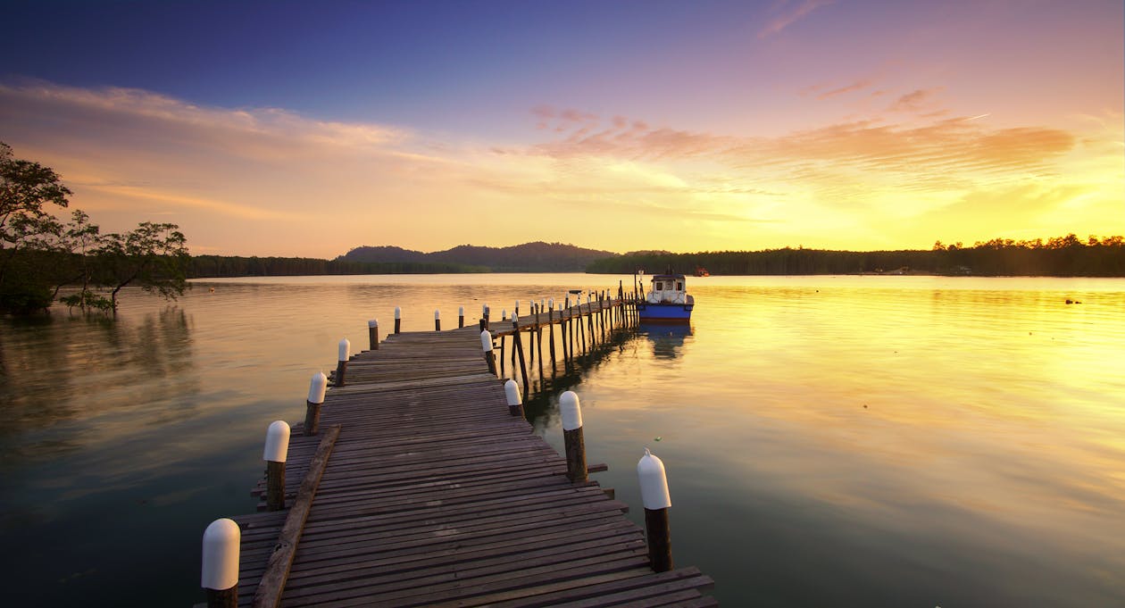 Brown Dock Near Body of Water