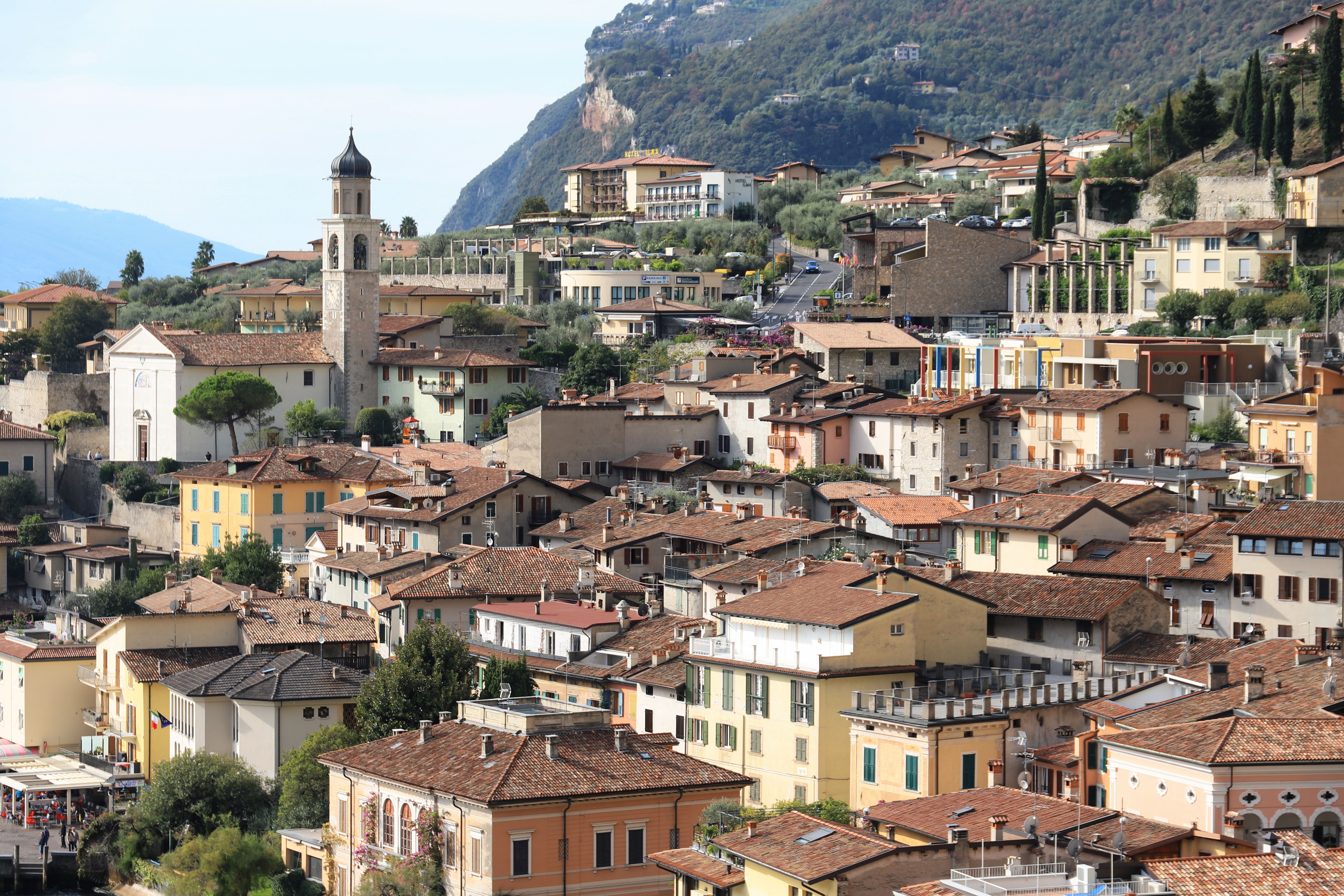 Charming hillside view of Limone Sul Garda with rustic architecture and lake backdrop.