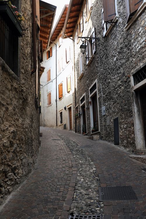Free Explore the charming historic alleys of Limone Sul Garda, Italy, lined with rustic stone architecture. Stock Photo