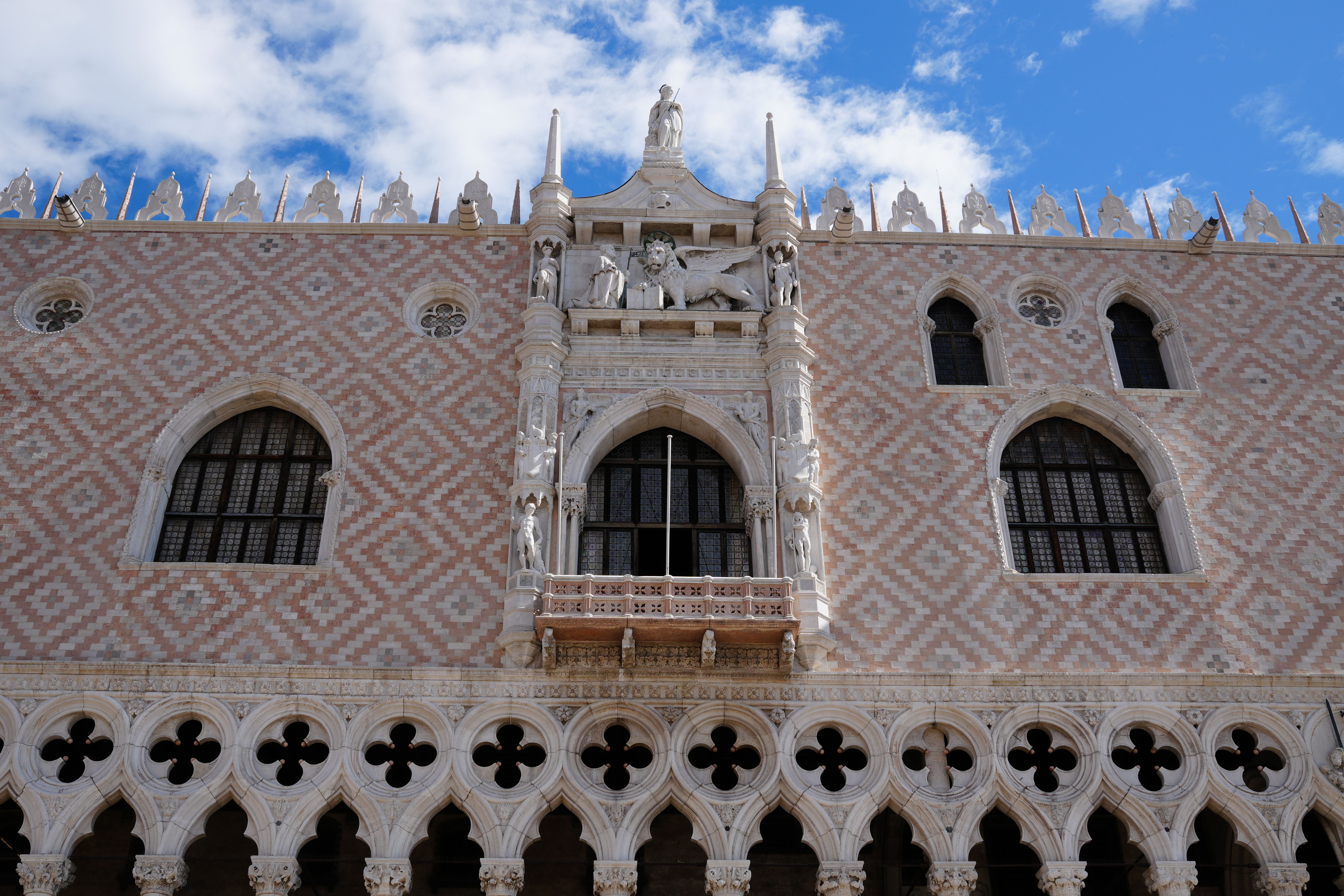 Explore the intricate Venetian Gothic architecture of Doge's Palace in Venice, Italy.