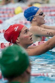 Focused swimmers at poolside during a competitive swim meet in Australia.