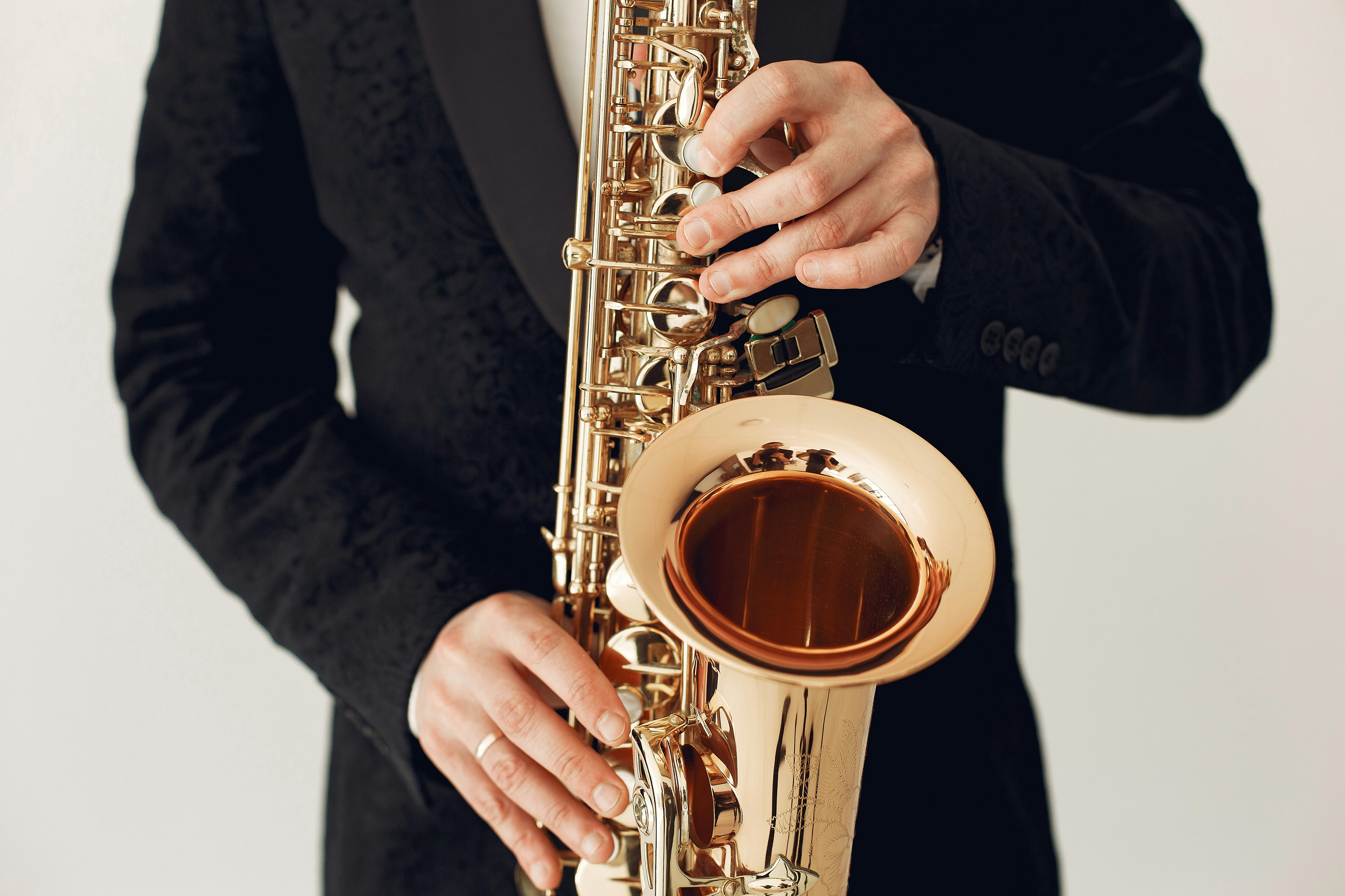 Crop man playing saxophone during concert · Free Stock Photo