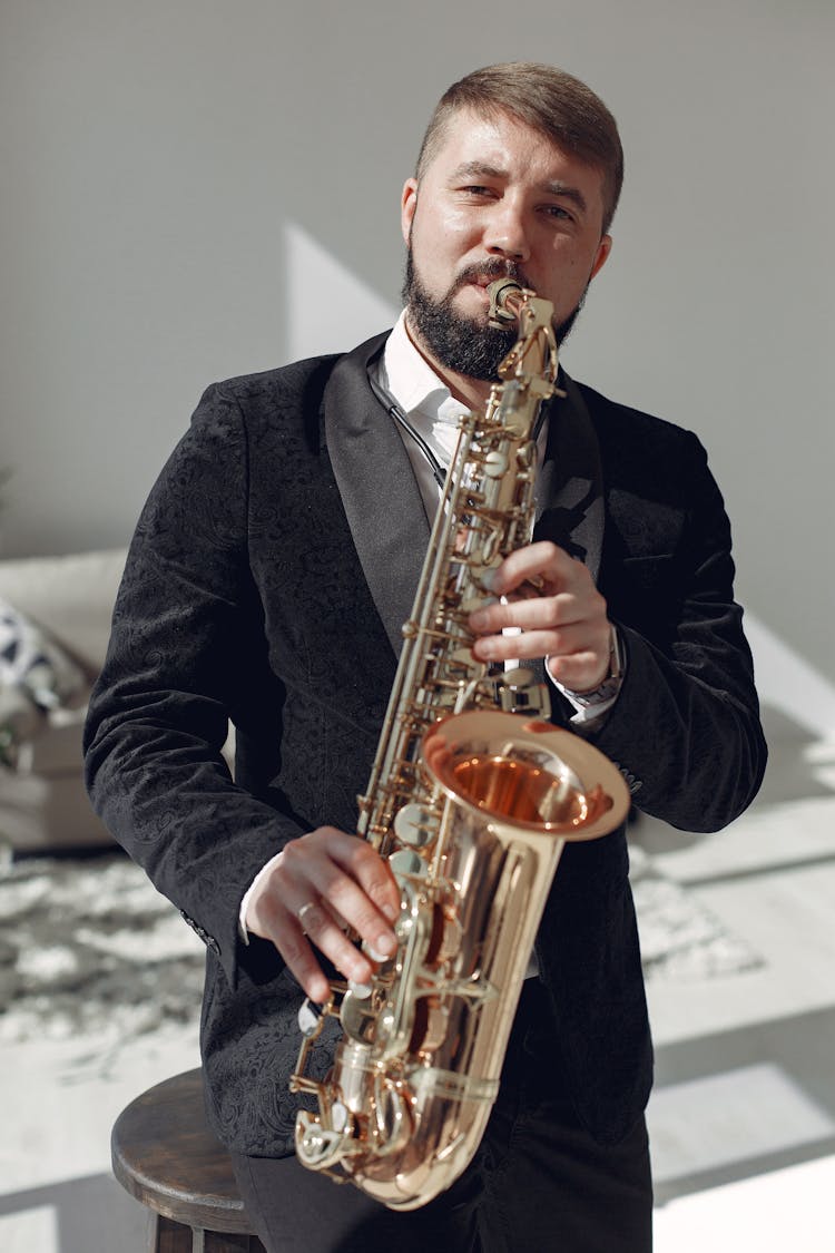 Adult Man Playing Saxophone On Concert