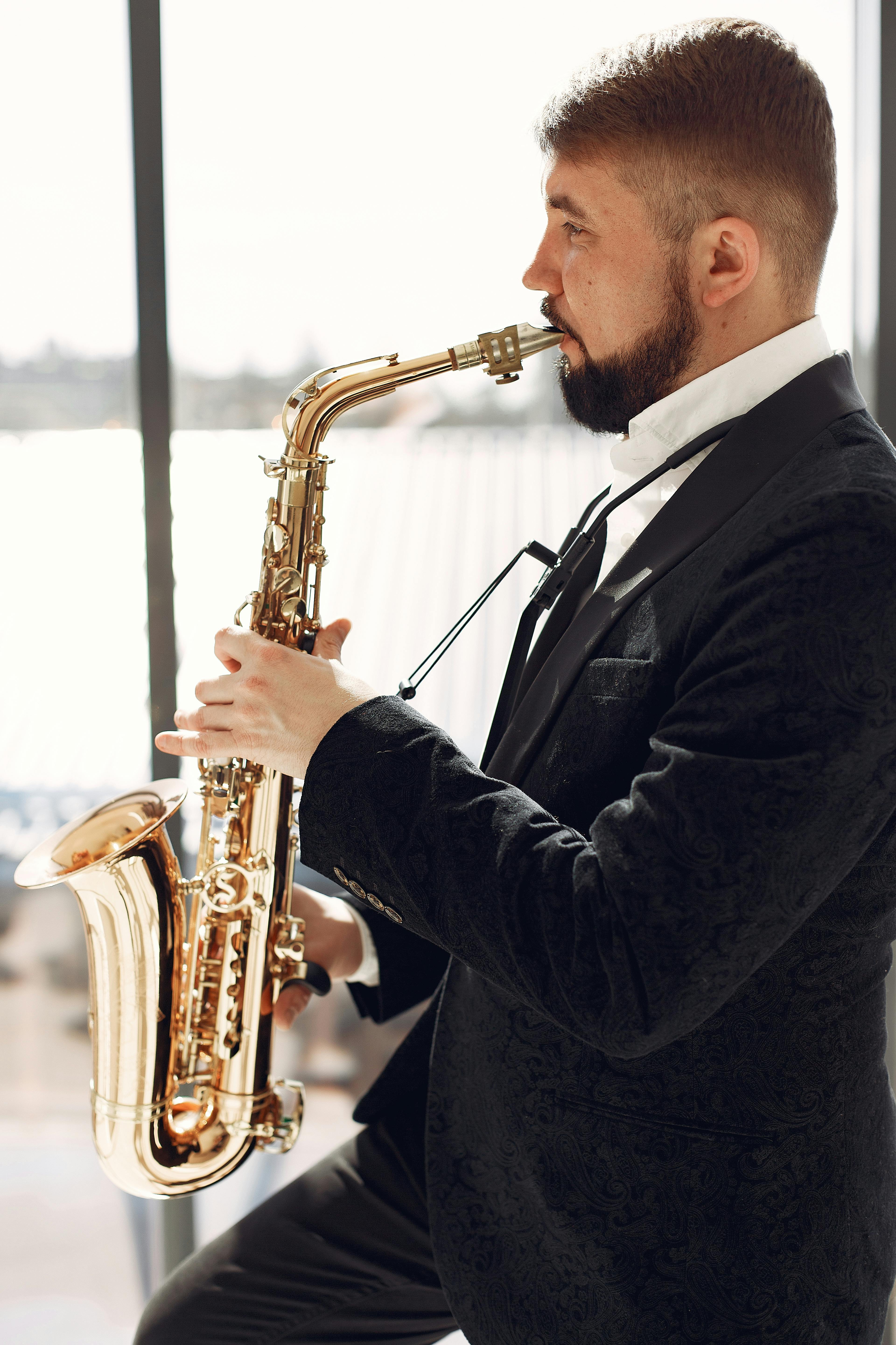 adult man playing saxophone on event with inspiration