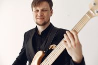 Man in Black Suit Playing Brown Acoustic Guitar
