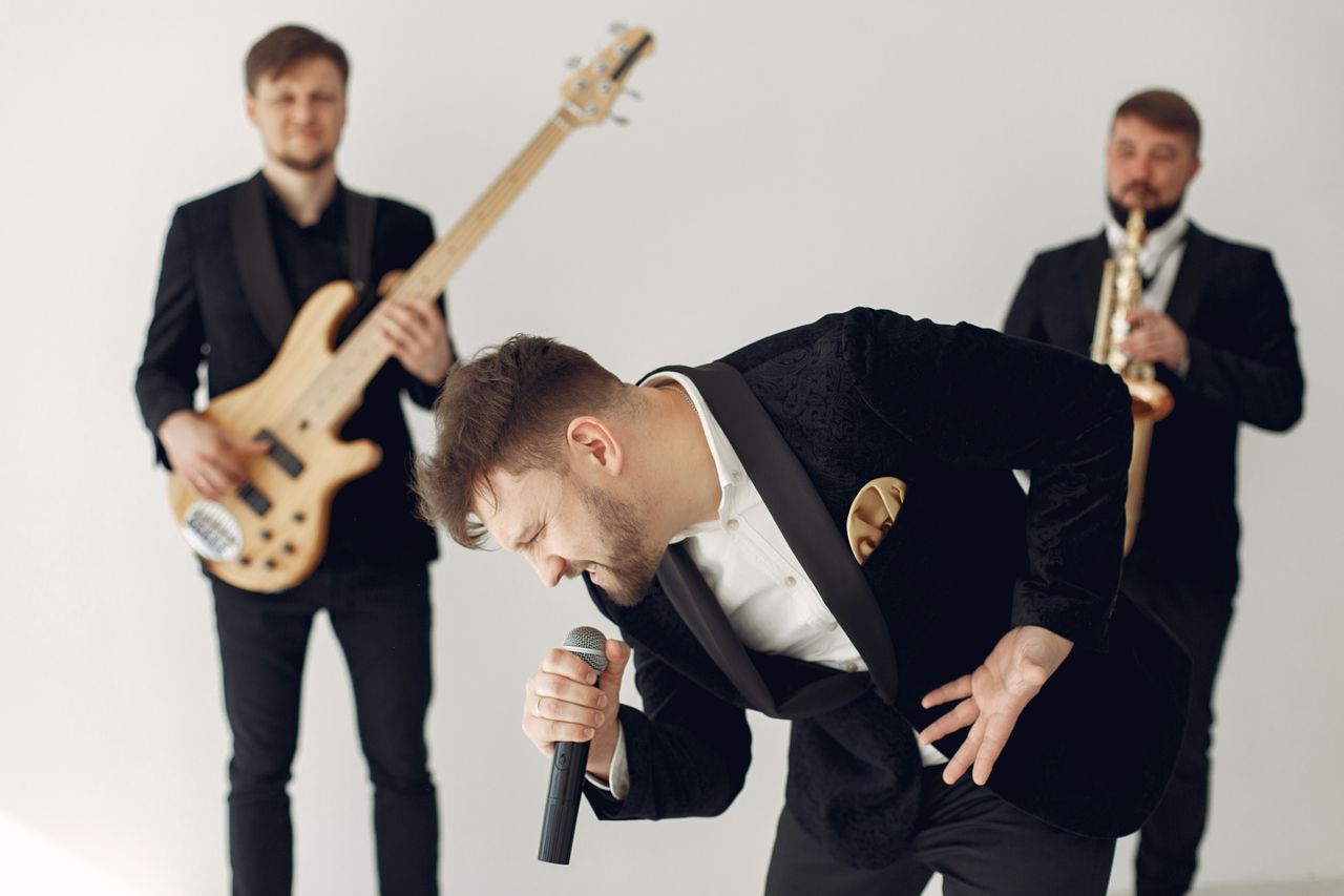 energetic music band with singer guitarist and saxophonist performing