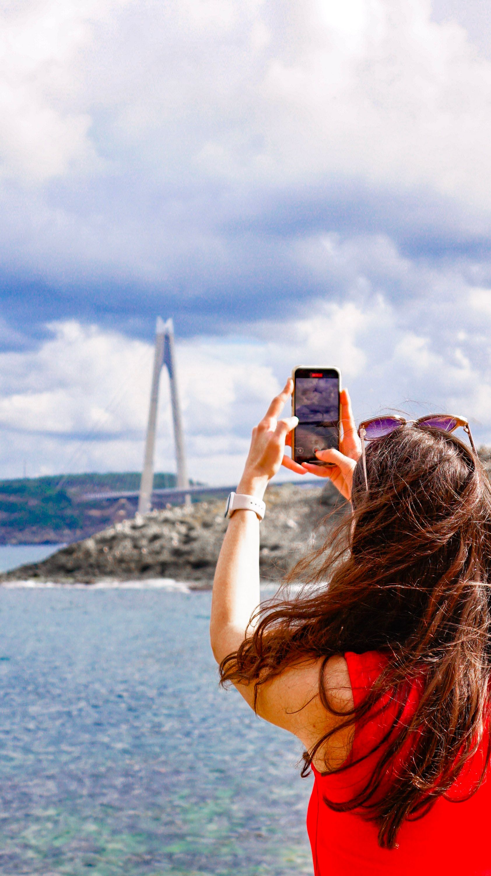 A woman photographs the Yavuz Sultan Selim Bridge in Garipçe, Istanbul.