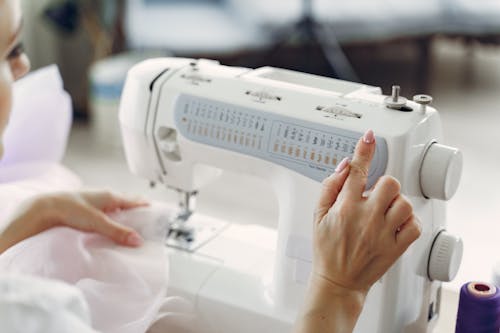 Free Person Using White Sewing Machine Stock Photo