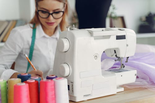 Dressmaker in front of her Sewing Machine