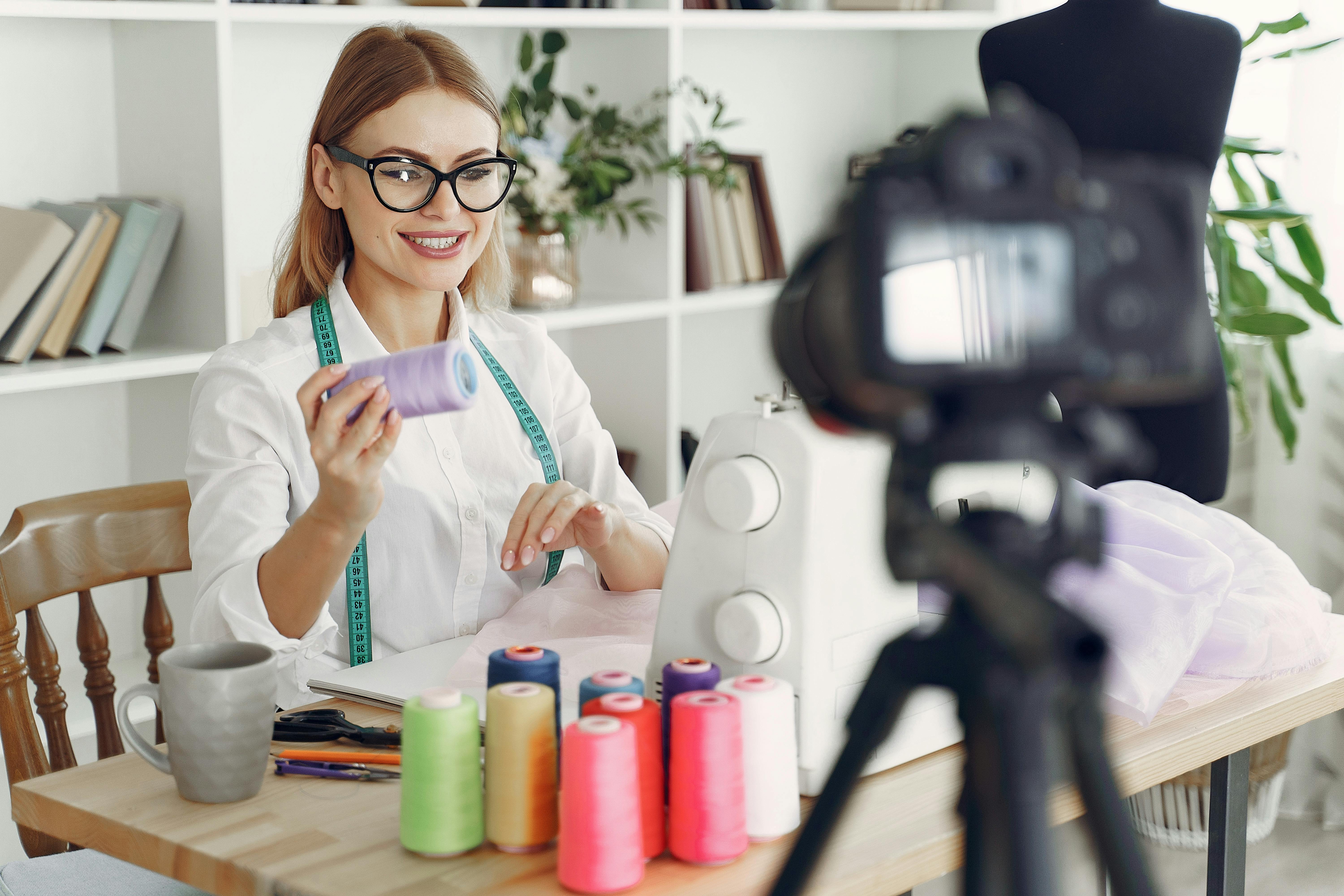 dressmaker in front of her sewing machine and camera