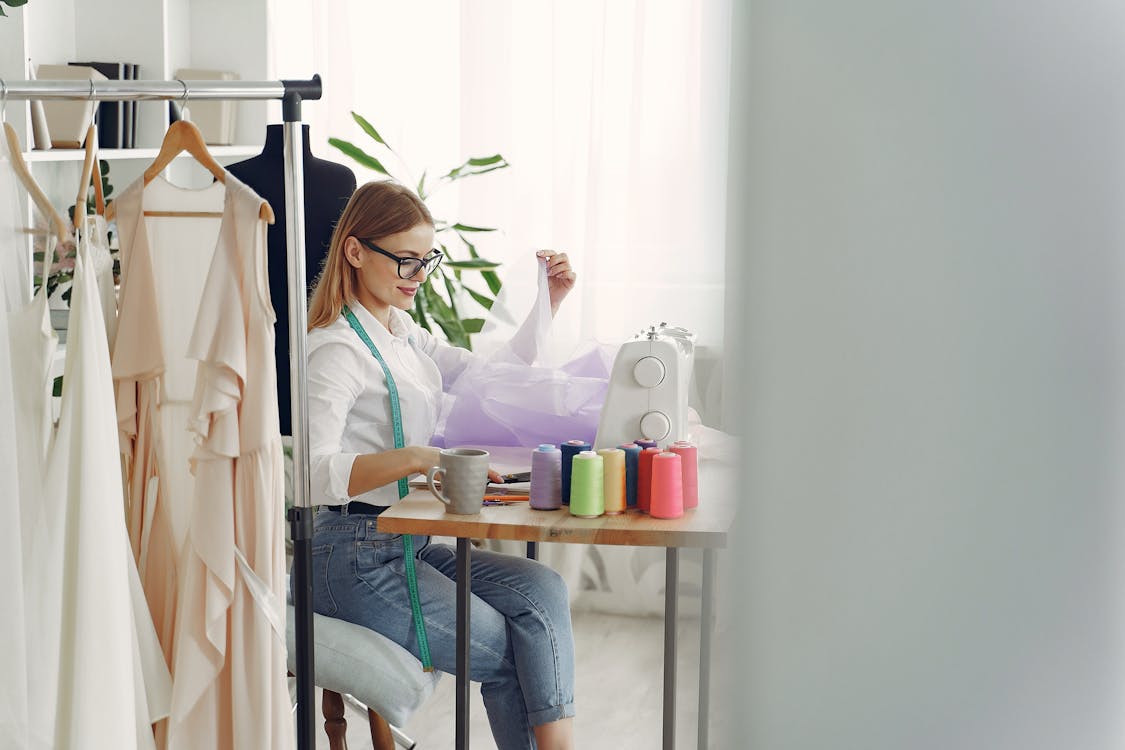 Free Busy Dressmaker in front of her Sewing Machine Stock Photo