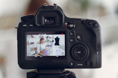 Free Black Dslr Camera Filming a Woman in front of Sewing Machine  Stock Photo