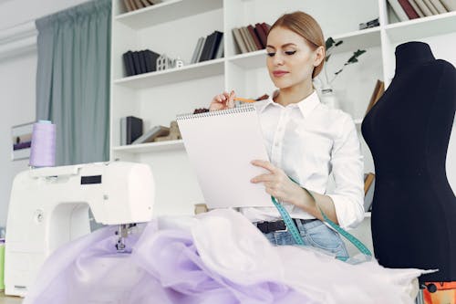 Woman in White Dress Shirt Holding White Paper