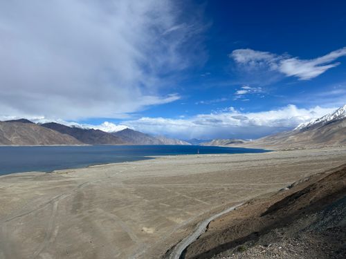 Free A breathtaking view of Pangong Lake surrounded by mountains under a clear blue sky. Stock Photo