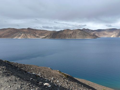 Free Breathtaking view of Pangong Lake's clear blue waters under a cloudy sky in Ladakh, India. Stock Photo