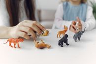 Unrecognizable woman playing with little girl