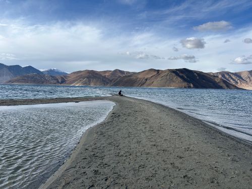 Free A breathtaking view of Pangong Lake surrounded by rugged mountains, under a clear blue sky. Stock Photo