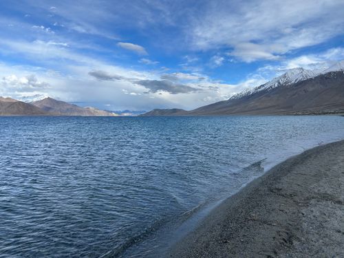 Free Breathtaking view of Pangong Tso Lake with mountain backdrop under a vibrant sky. Stock Photo