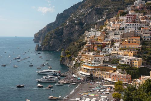 Free Scenic view of Positano's colorful buildings on the Amalfi Coast with boats on the sea. Stock Photo