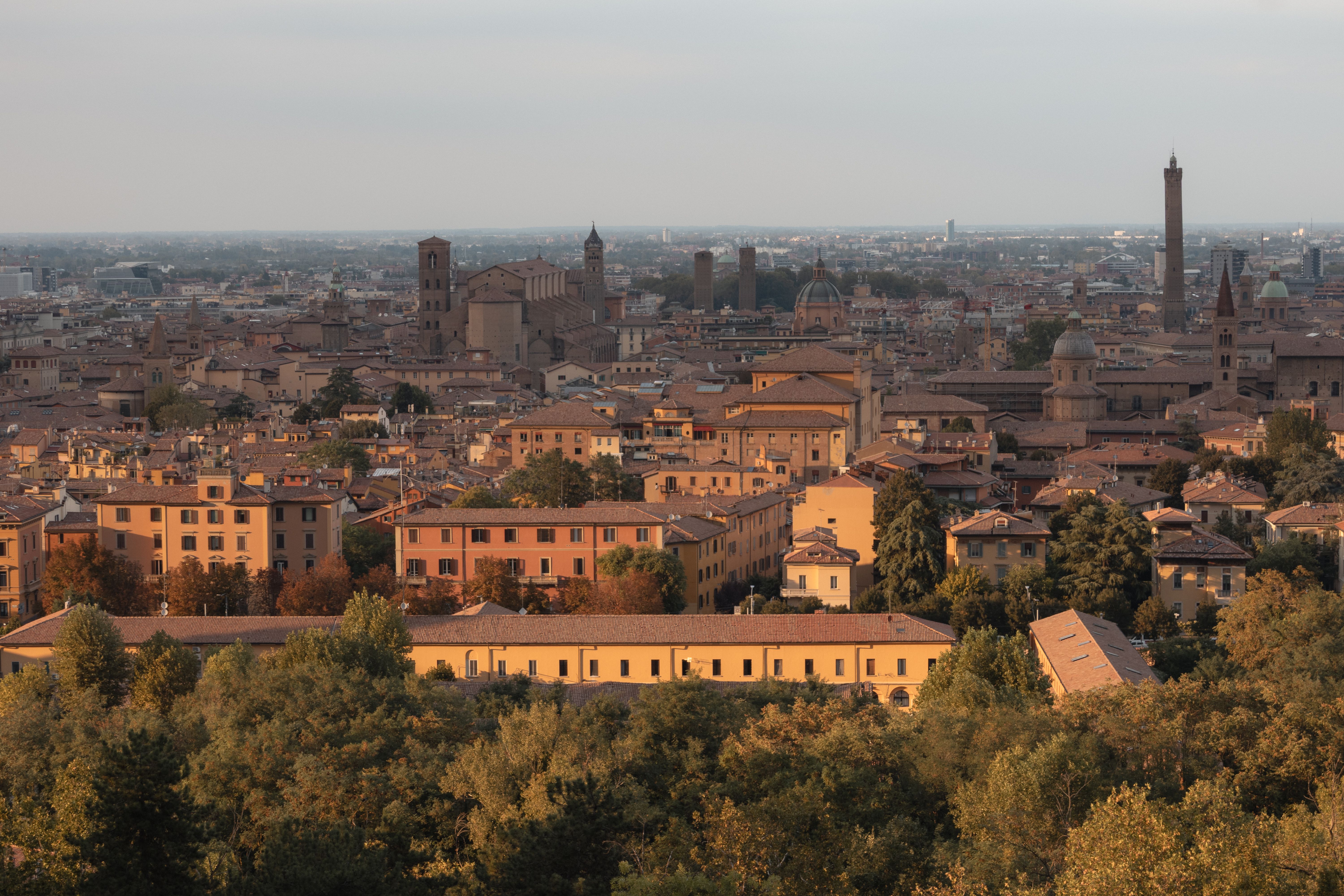 A stunning aerial view of Bologna, Italy showcasing historic architecture and iconic towers at dusk.