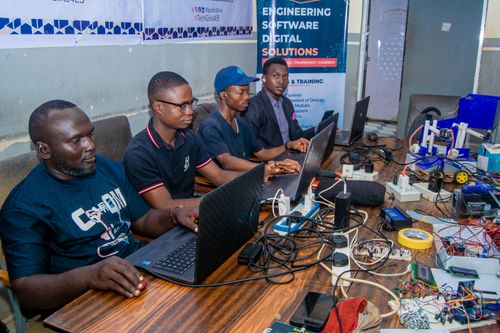 Free Group of engineers working together on digital solutions in a collaborative workspace. Stock Photo