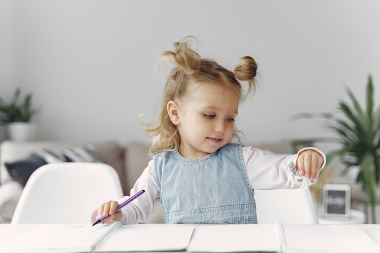 Little Girl Playing With Zebra Toy Figure