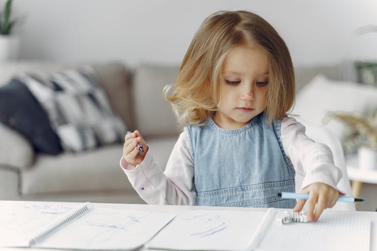 Little Girl Holding Color Pens