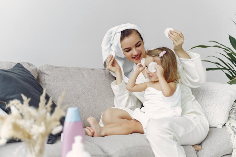 Woman In White Robe Sitting On Couch